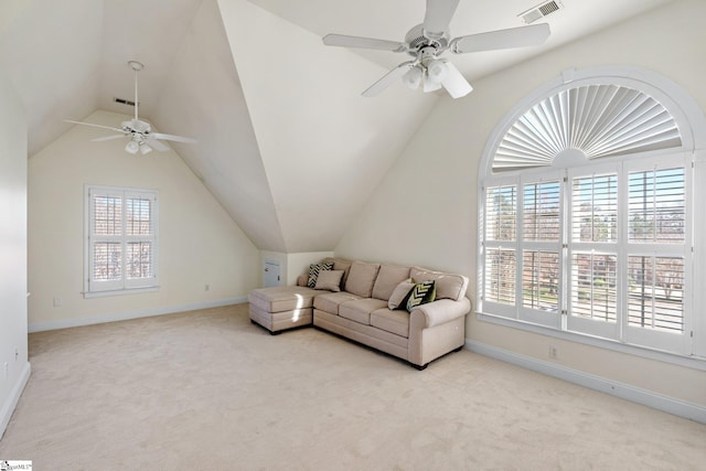 carpeted living area with a wealth of natural light, visible vents, ceiling fan, and vaulted ceiling