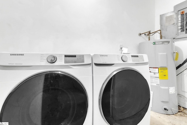 washroom with washer and dryer, electric water heater, and laundry area