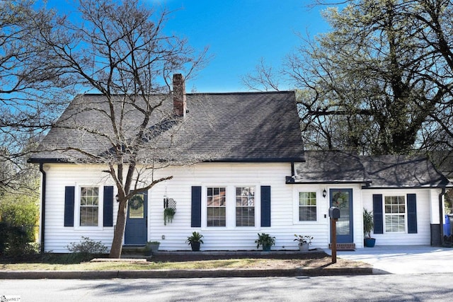 cape cod-style house with a chimney