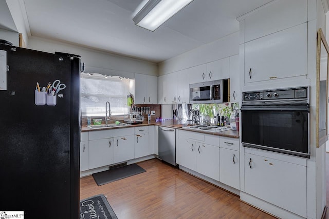 129 Canty Way, Gaffney, SC 29341 - kitchen with black appliances, a sink, dark countertops, wood finished floors, and white cabinets
