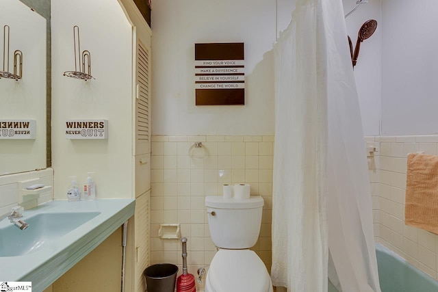 129 Canty Way, Gaffney, SC 29341 - bathroom featuring vanity, wainscoting, tile walls, toilet, and shower / tub combo with curtain
