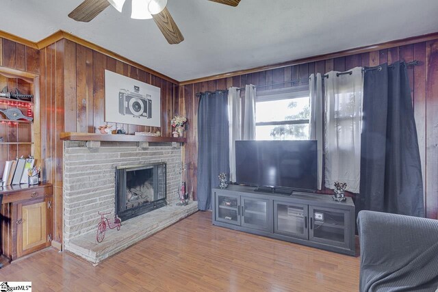129 Canty Way, Gaffney, SC 29341 - living room featuring wooden walls, a brick fireplace, a ceiling fan, and wood finished floors