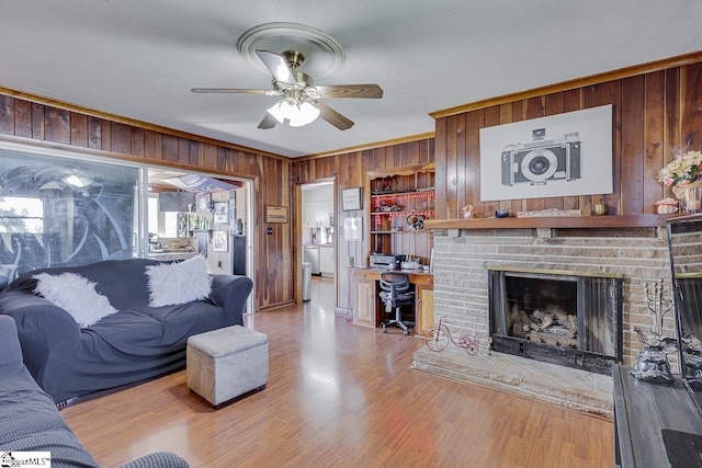 129 Canty Way, Gaffney, SC 29341 - living room with wood finished floors, wood walls, crown molding, a brick fireplace, and ceiling fan