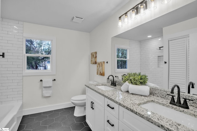 full bath with a sink, baseboards, toilet, and tile patterned floors