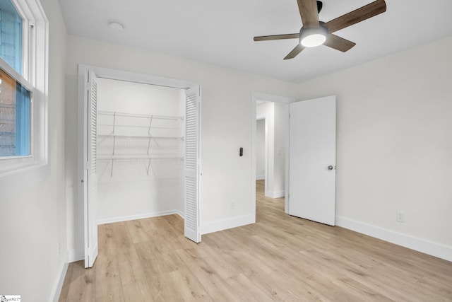 unfurnished bedroom with a ceiling fan, light wood-style flooring, baseboards, and a closet