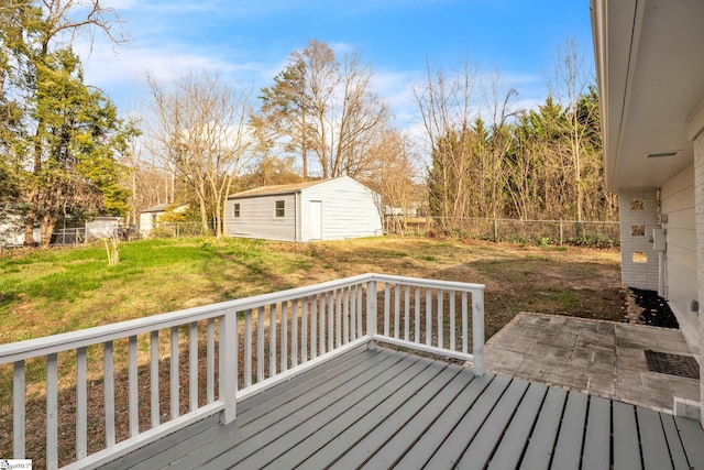 deck with a yard, an outbuilding, and a fenced backyard
