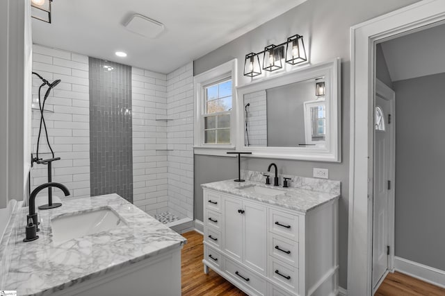 510 N Franklin Rd, Greenville, SC 29609 - bathroom with wood finished floors, two vanities, tiled shower, and a sink