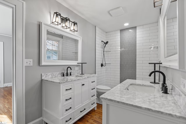 510 N Franklin Rd, Greenville, SC 29609 - bathroom featuring tiled shower, vanity, and wood finished floors