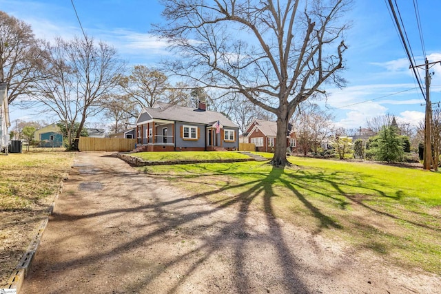 510 N Franklin Rd, Greenville, SC 29609 - view of front of house with a shingled roof, fence, a front yard, a chimney, and driveway