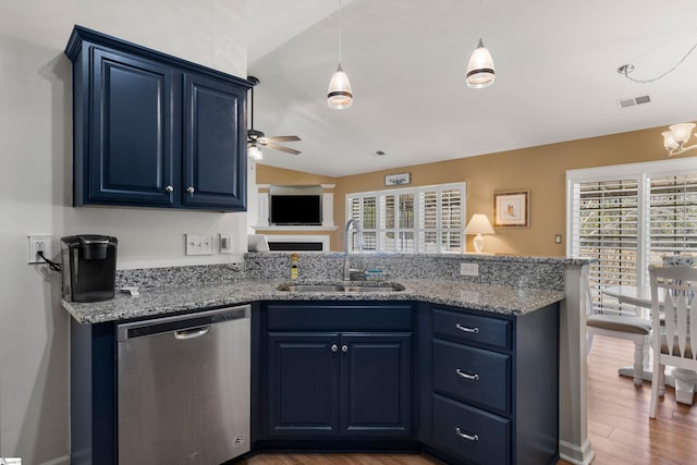 kitchen featuring visible vents, a peninsula, stainless steel dishwasher, blue cabinets, and a sink