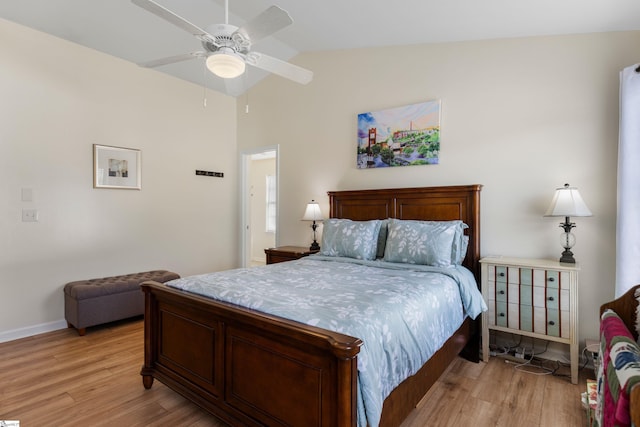bedroom with vaulted ceiling, a ceiling fan, baseboards, and light wood finished floors