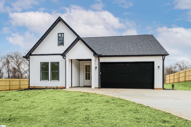 modern farmhouse with a shingled roof, concrete driveway, a front yard, and fence