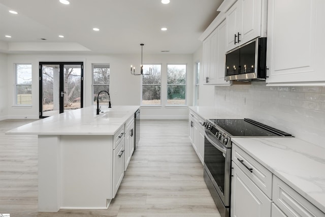 kitchen featuring plenty of natural light, recessed lighting, appliances with stainless steel finishes, and a sink