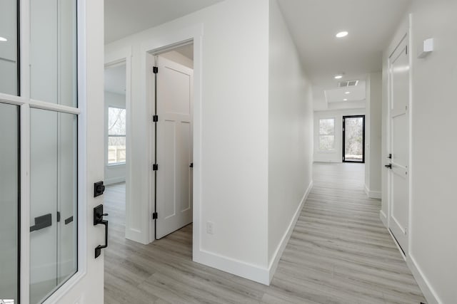 hall with recessed lighting, baseboards, light wood-style floors, and a healthy amount of sunlight