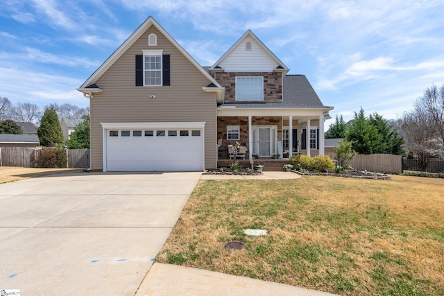 39 Santee Ct, Simpsonville, SC 29680 - traditional home featuring fence, a front yard, covered porch, stone siding, and driveway