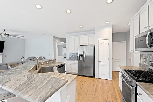 39 Santee Ct, Simpsonville, SC 29680 - kitchen featuring a sink, stainless steel appliances, white cabinets, and a ceiling fan