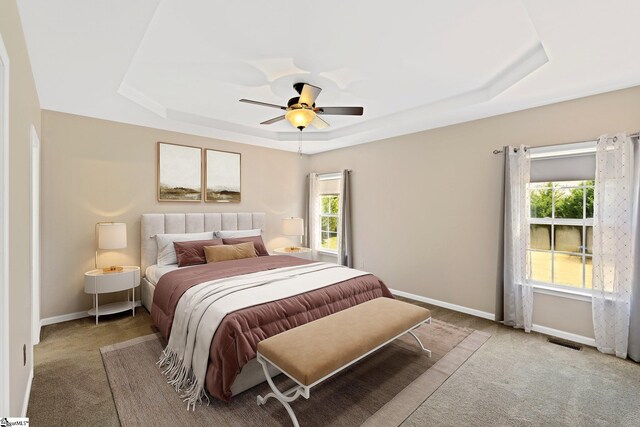 39 Santee Ct, Simpsonville, SC 29680 - carpeted bedroom featuring a ceiling fan, a tray ceiling, baseboards, and visible vents