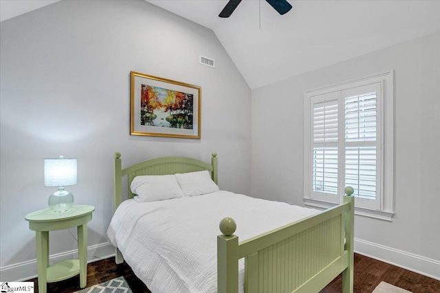 bedroom featuring visible vents, baseboards, wood finished floors, a ceiling fan, and vaulted ceiling