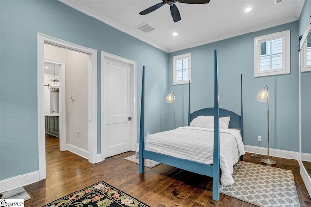bedroom featuring baseboards, visible vents, ornamental molding, and hardwood / wood-style floors