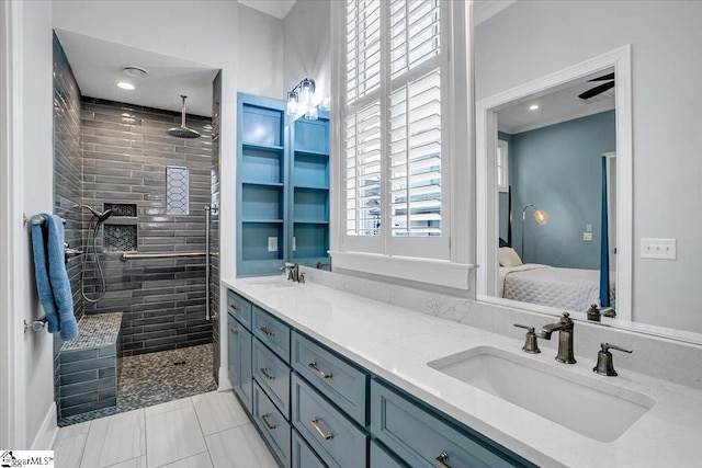 ensuite bathroom with ensuite bathroom, a sink, and a tile shower
