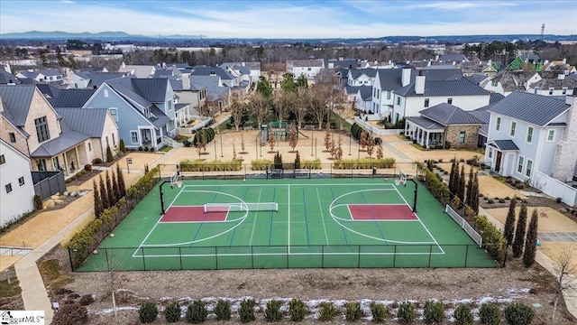 view of sport court with community basketball court, fence, and a residential view