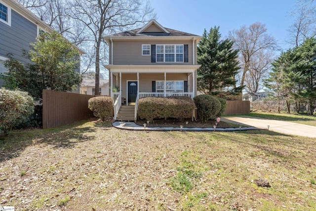 view of front of house with a porch and fence
