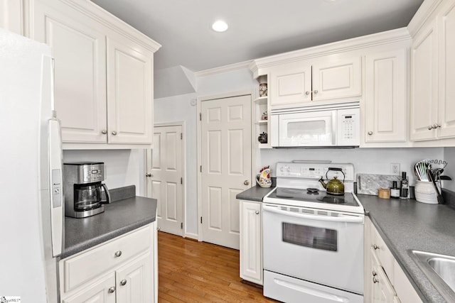kitchen with white cabinetry, white appliances, and dark countertops