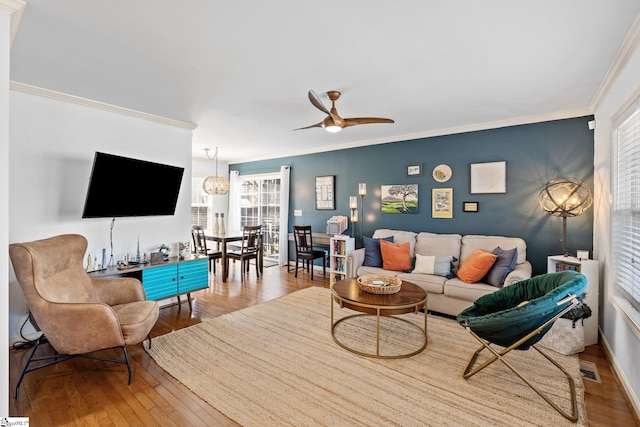 living room featuring ornamental molding, a ceiling fan, and hardwood / wood-style floors