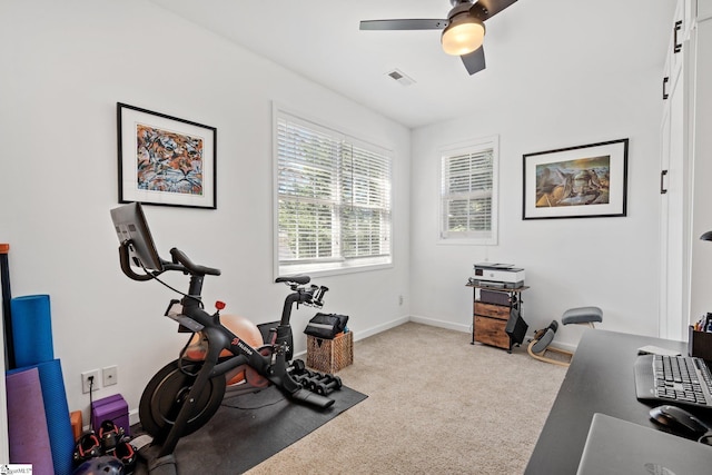 exercise area featuring visible vents, baseboards, a ceiling fan, and carpet flooring