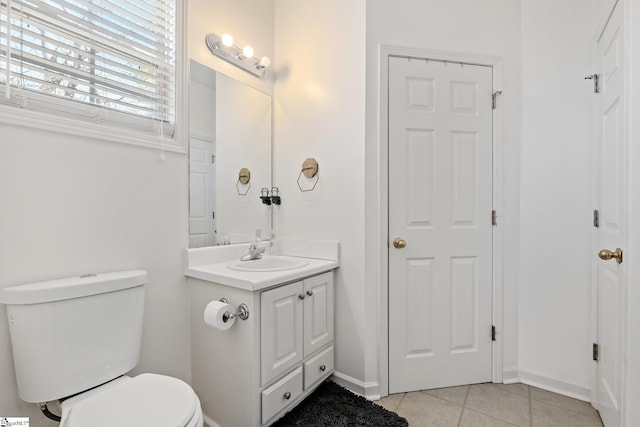 bathroom with vanity, tile patterned floors, toilet, and baseboards