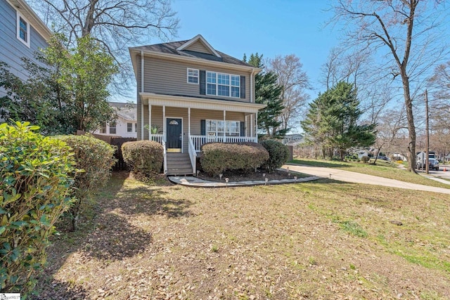 view of front of house featuring a front lawn and covered porch