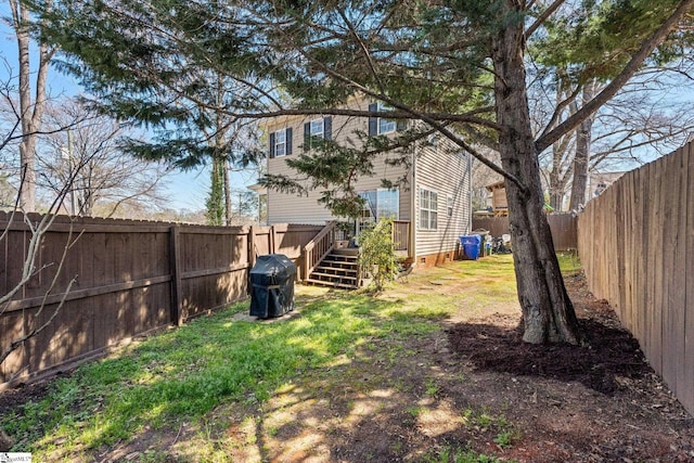 view of yard featuring a wooden deck and a fenced backyard