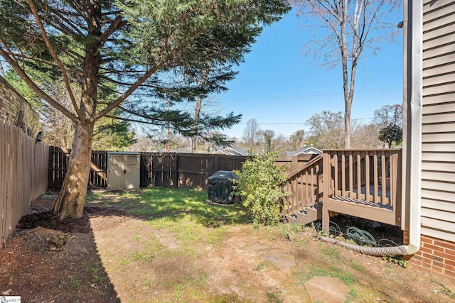 view of yard with a fenced backyard and a wooden deck