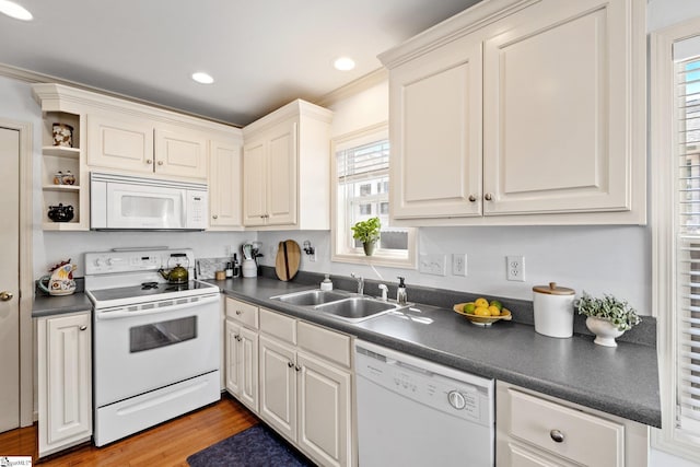 kitchen featuring dark countertops, light wood-type flooring, white appliances, white cabinetry, and a sink