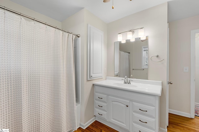 bathroom with vanity, baseboards, and wood finished floors