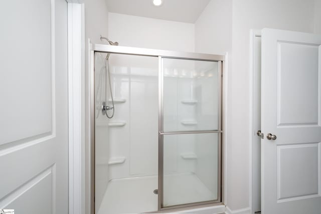bathroom featuring recessed lighting and a stall shower