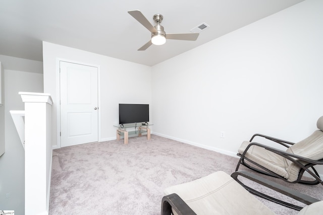 sitting room with visible vents, an upstairs landing, carpet, baseboards, and ceiling fan