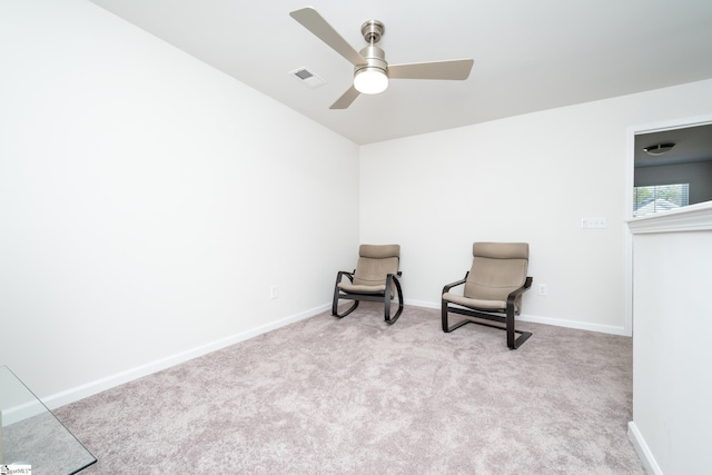 sitting room with visible vents, baseboards, carpet, and a ceiling fan