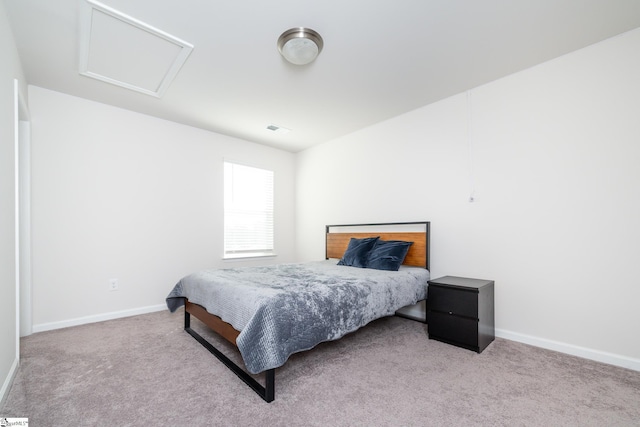 carpeted bedroom with visible vents, baseboards, and attic access