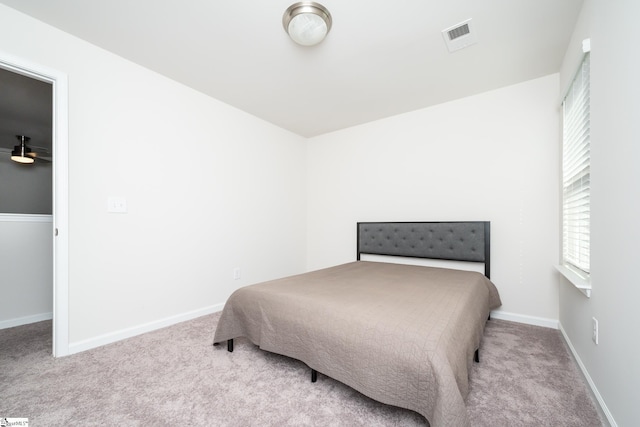 bedroom with visible vents, carpet floors, and baseboards