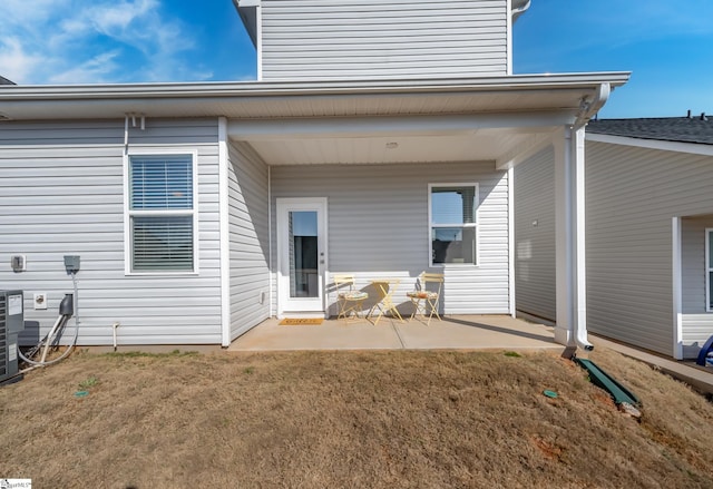 rear view of house with a patio and a yard