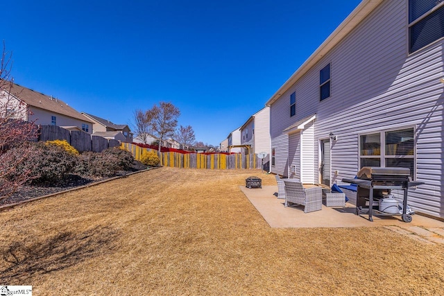 view of yard featuring a patio, a fenced backyard, and a residential view