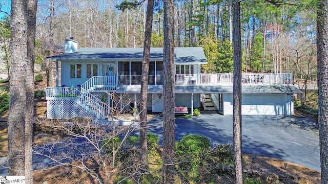 545 Long Reach Dr, Salem, SC 29676 - view of front of home featuring a sunroom, a garage, aphalt driveway, a chimney, and stairway