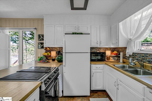 545 Long Reach Dr, Salem, SC 29676 - kitchen with a sink, freestanding refrigerator, white cabinetry, and stainless steel range with electric stovetop