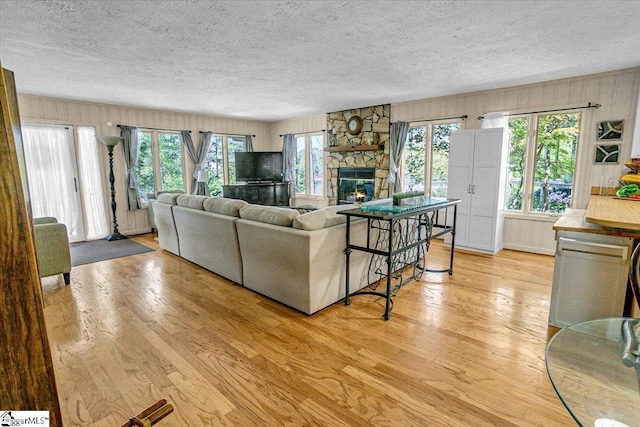 545 Long Reach Dr, Salem, SC 29676 - living area with light wood-style flooring, a stone fireplace, and a textured ceiling