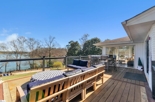 deck featuring a water view and outdoor lounge area