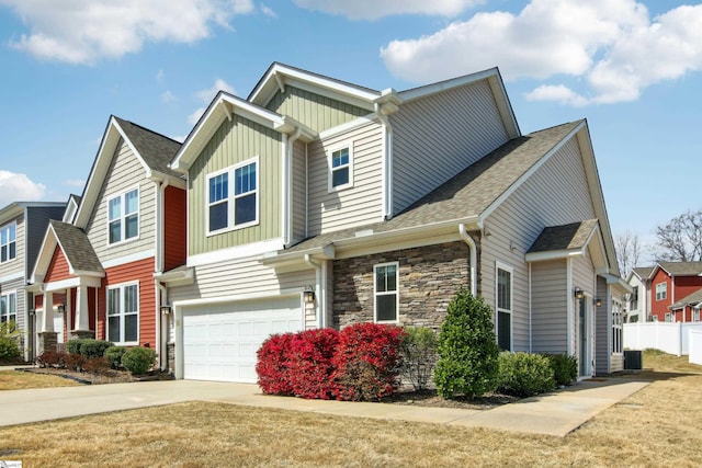 31 Creekhaven Ln, Taylors, SC 29687 - craftsman-style home featuring stone siding, fence, board and batten siding, concrete driveway, and an attached garage