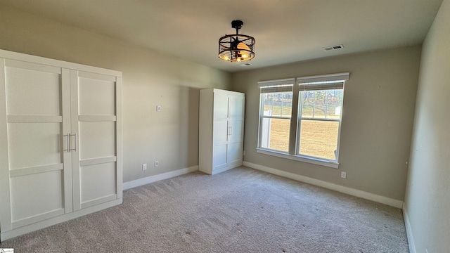31 Creekhaven Ln, Taylors, SC 29687 - unfurnished bedroom with an inviting chandelier, visible vents, baseboards, and light carpet