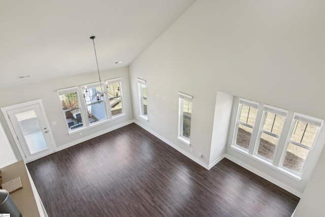 31 Creekhaven Ln, Taylors, SC 29687 - unfurnished living room with visible vents, dark wood-type flooring, a notable chandelier, high vaulted ceiling, and baseboards