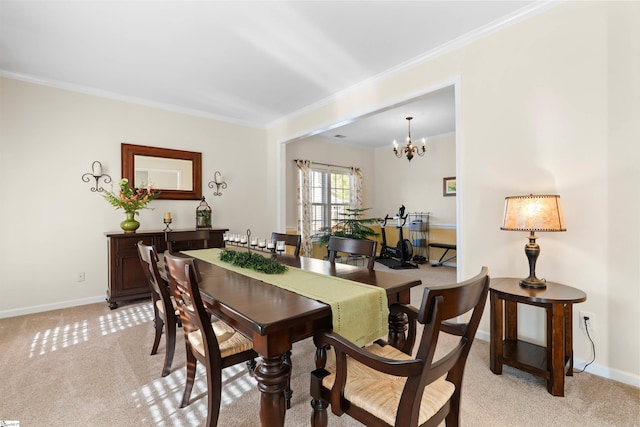 dining area featuring baseboards, light carpet, a chandelier, and ornamental molding